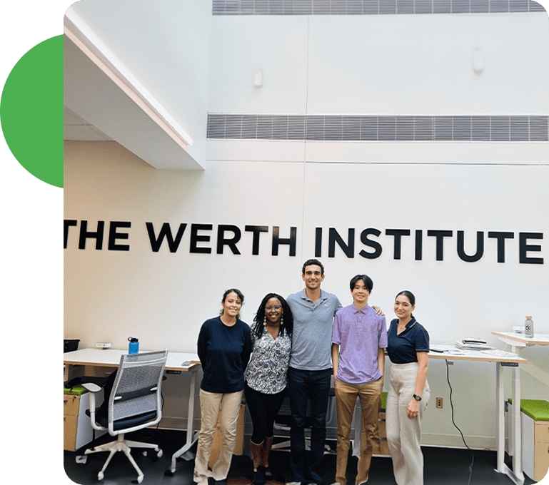 Five people standing in front of a wall with the words " the werth institut ".